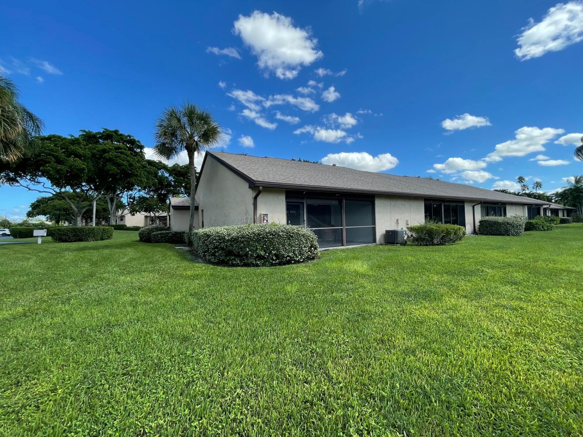 8471 Boca Glades Boulevard East Boca Raton, FL 33434 - Photo 4 of 29 a front view of house with a garden