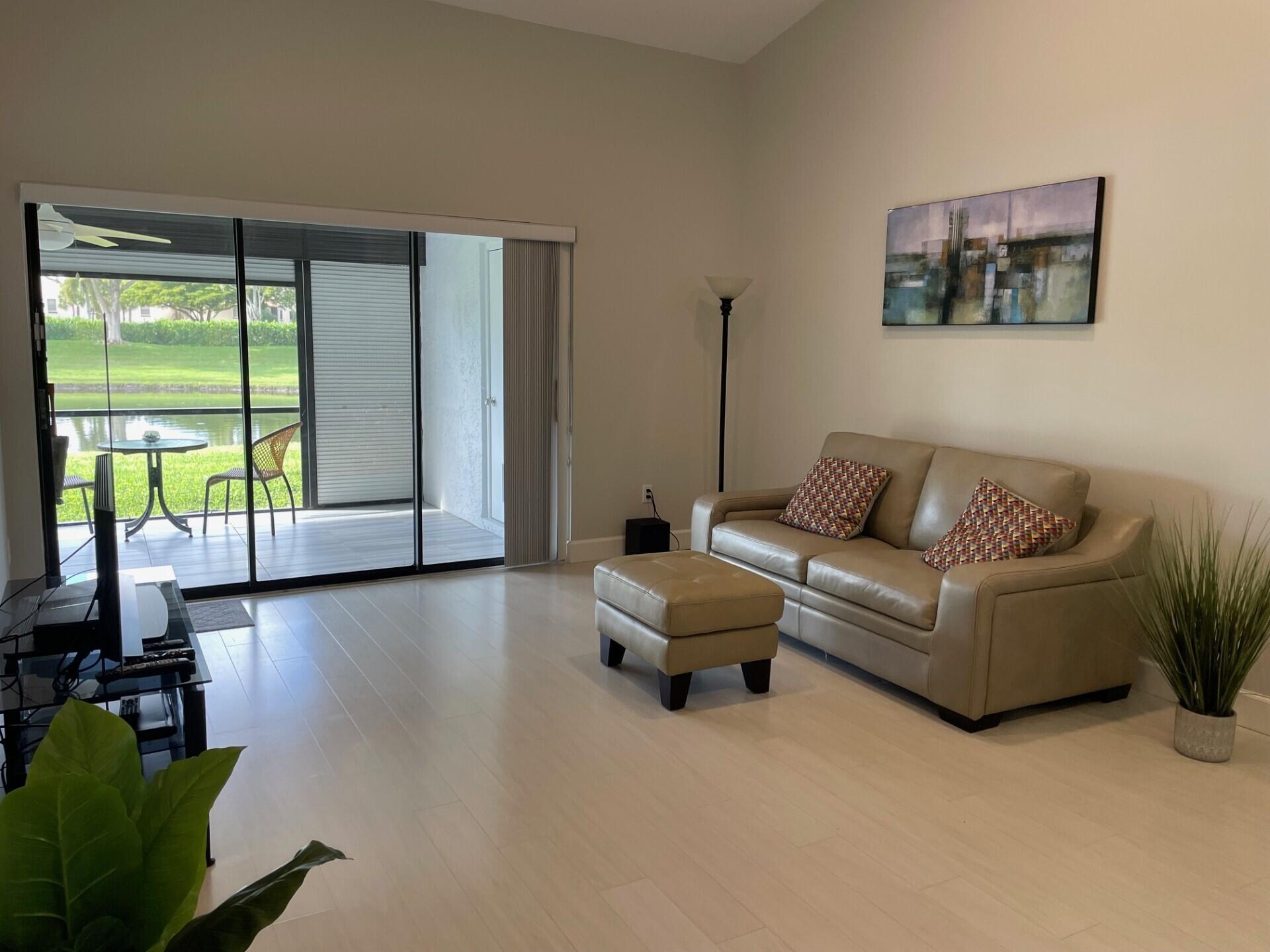 8471 Boca Glades Boulevard East Boca Raton, FL 33434 - Photo 5 of 29 a living room with furniture and a large window
