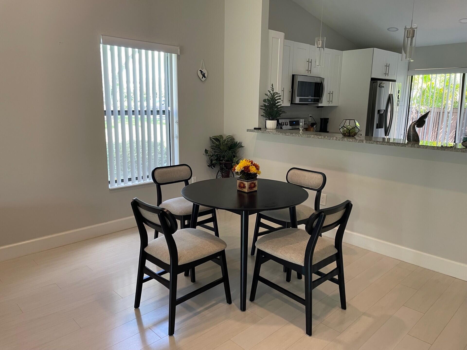 8471 Boca Glades Boulevard East Boca Raton, FL 33434 - Photo 6 of 29 a dining room with furniture and window
