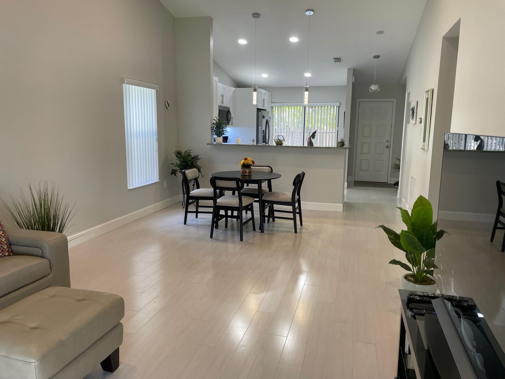 8471 Boca Glades Boulevard East Boca Raton, FL 33434 - Photo 7 of 29 a view of a dining room with furniture
