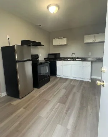 a kitchen with a refrigerator and a sink