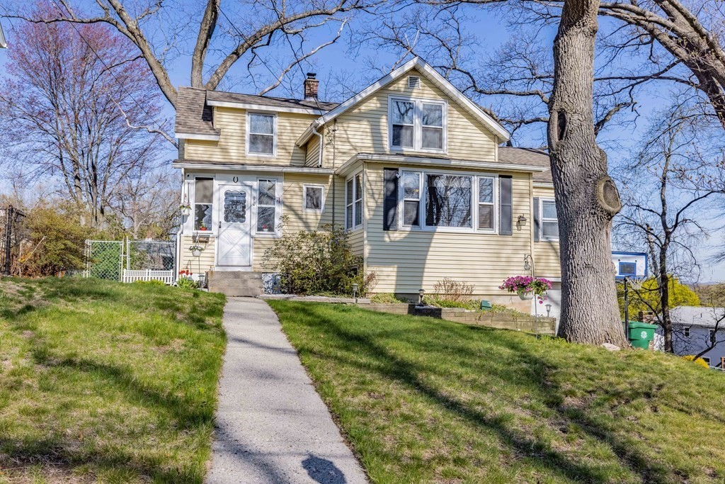 90 Rochester Street Chicopee, MA 01020 - Photo 2 of 31 a front view of a house with a yard and potted plants