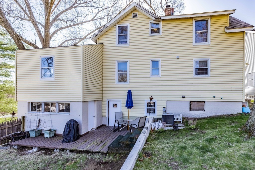 90 Rochester Street Chicopee, MA 01020 - Photo 26 of 31 a backyard of a house with wooden table and chairs