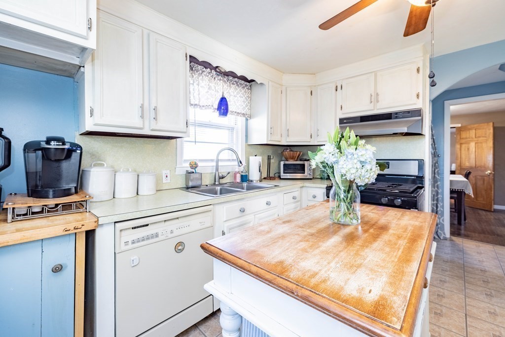 90 Rochester Street Chicopee, MA 01020 - Photo 6 of 31 a kitchen with kitchen island granite countertop a white cabinets and appliances