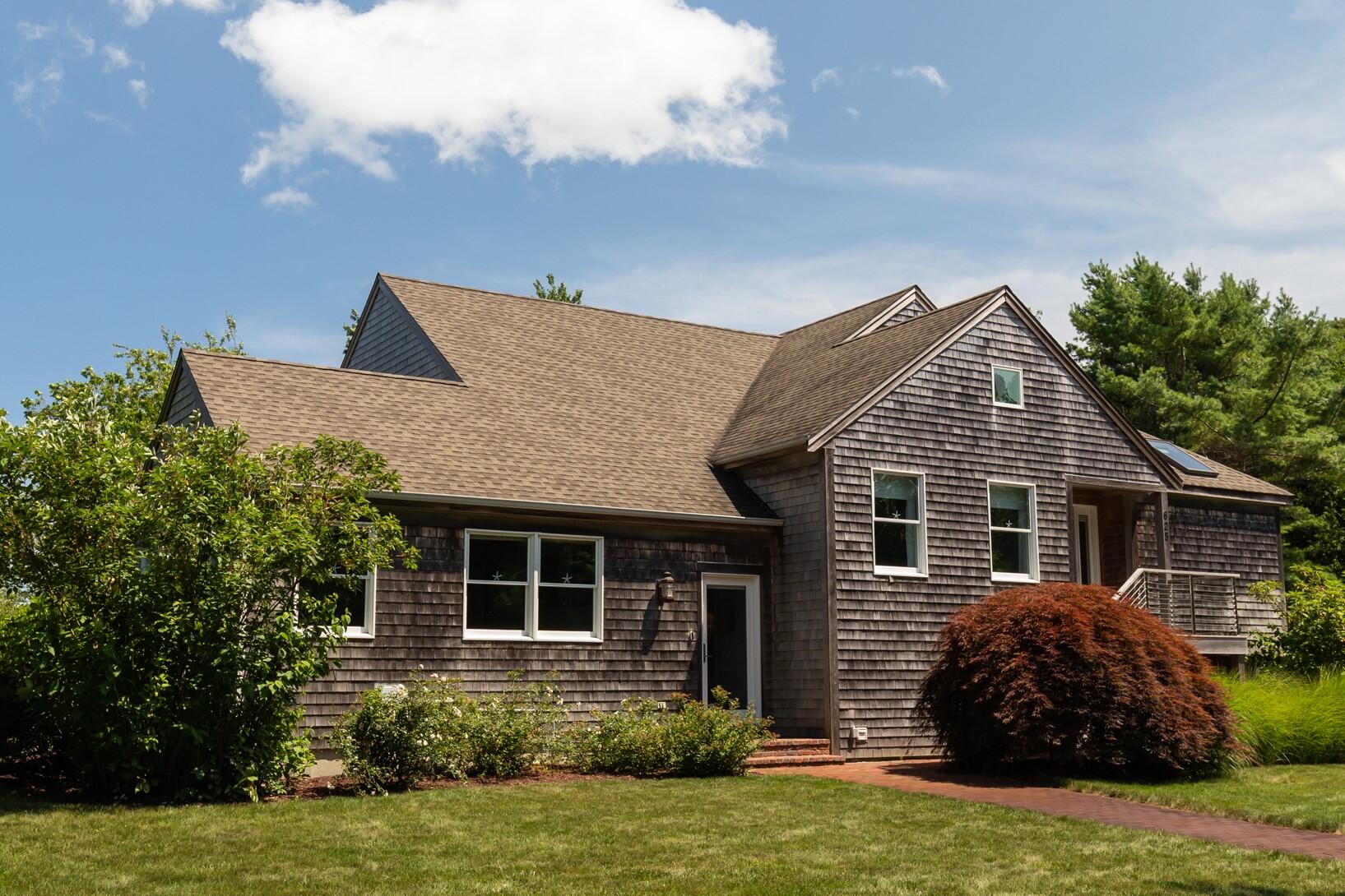 625 Samoset Road Eastham, MA 02642 - Photo 1 of 77 a front view of a house with a yard