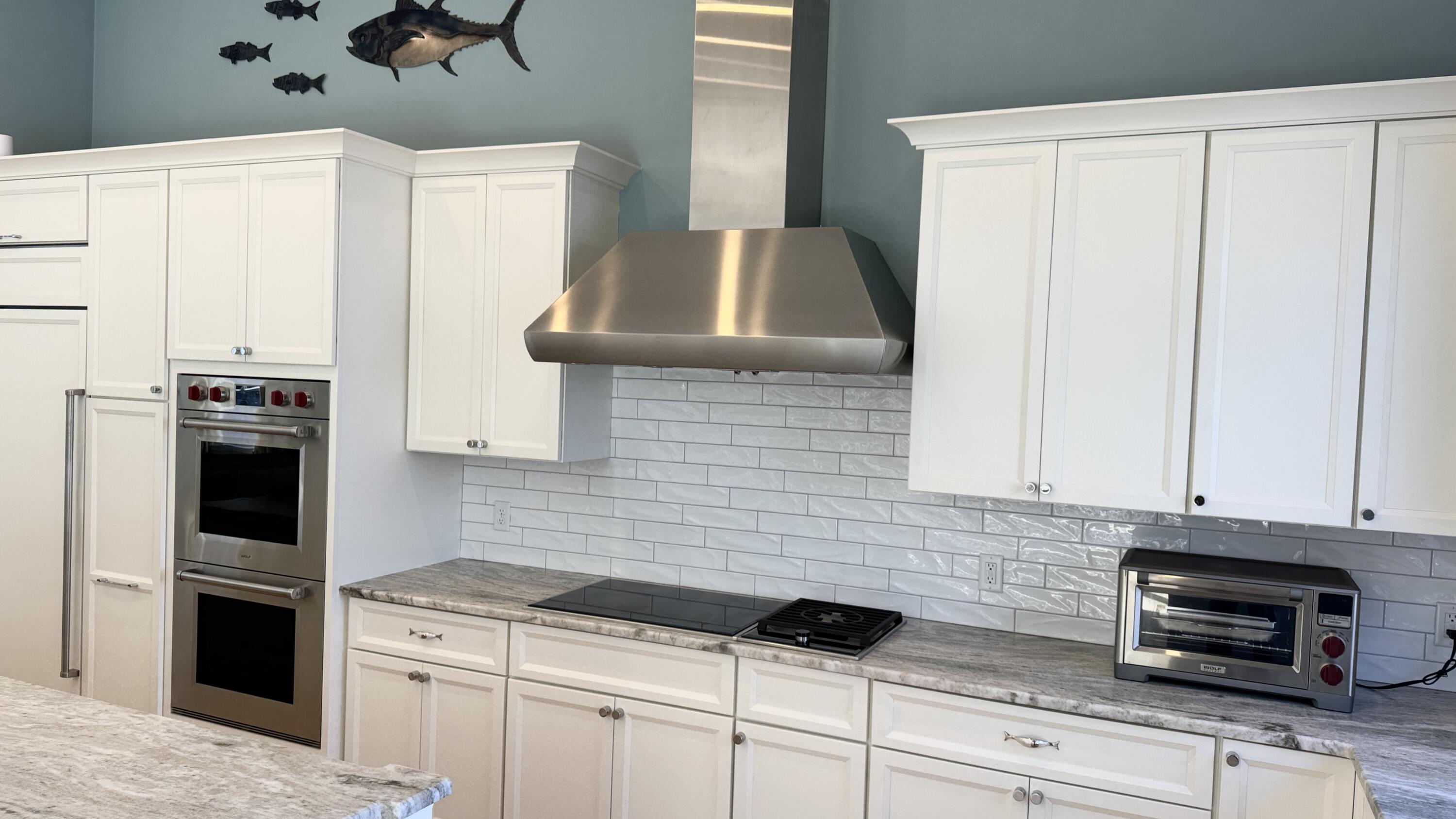 625 Samoset Road Eastham, MA 02642 - Photo 23 of 77 a kitchen with granite countertop a sink a stove and cabinets