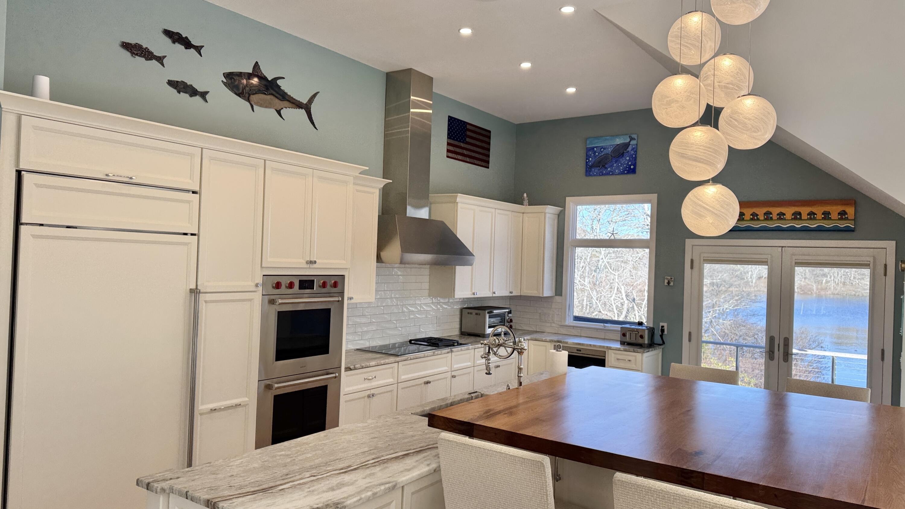 625 Samoset Road Eastham, MA 02642 - Photo 24 of 77 a kitchen with stainless steel appliances granite countertop a stove a kitchen island a stove and a sink