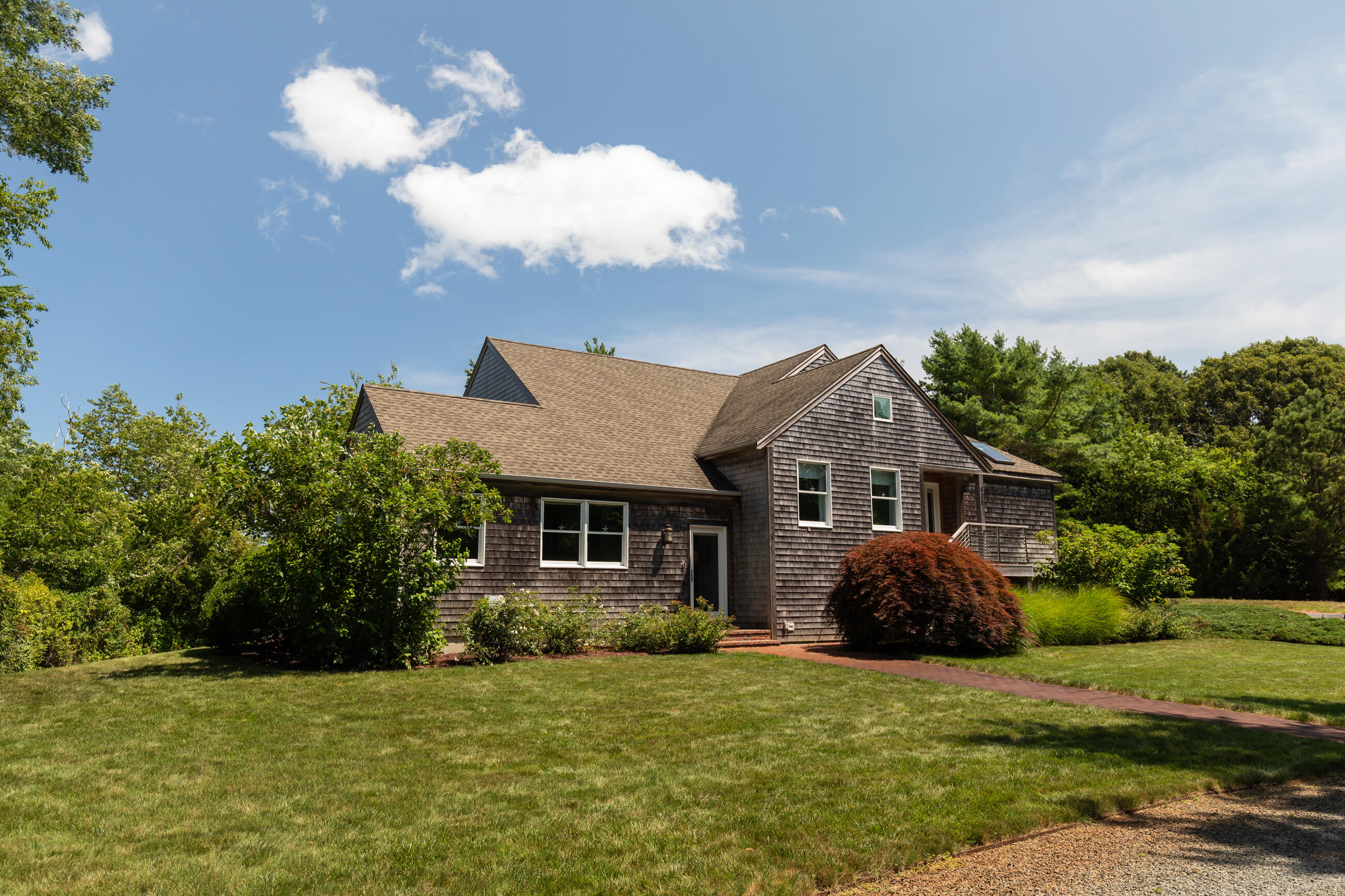 625 Samoset Road Eastham, MA 02642 - Photo 3 of 77 a front view of a house with a yard and garage