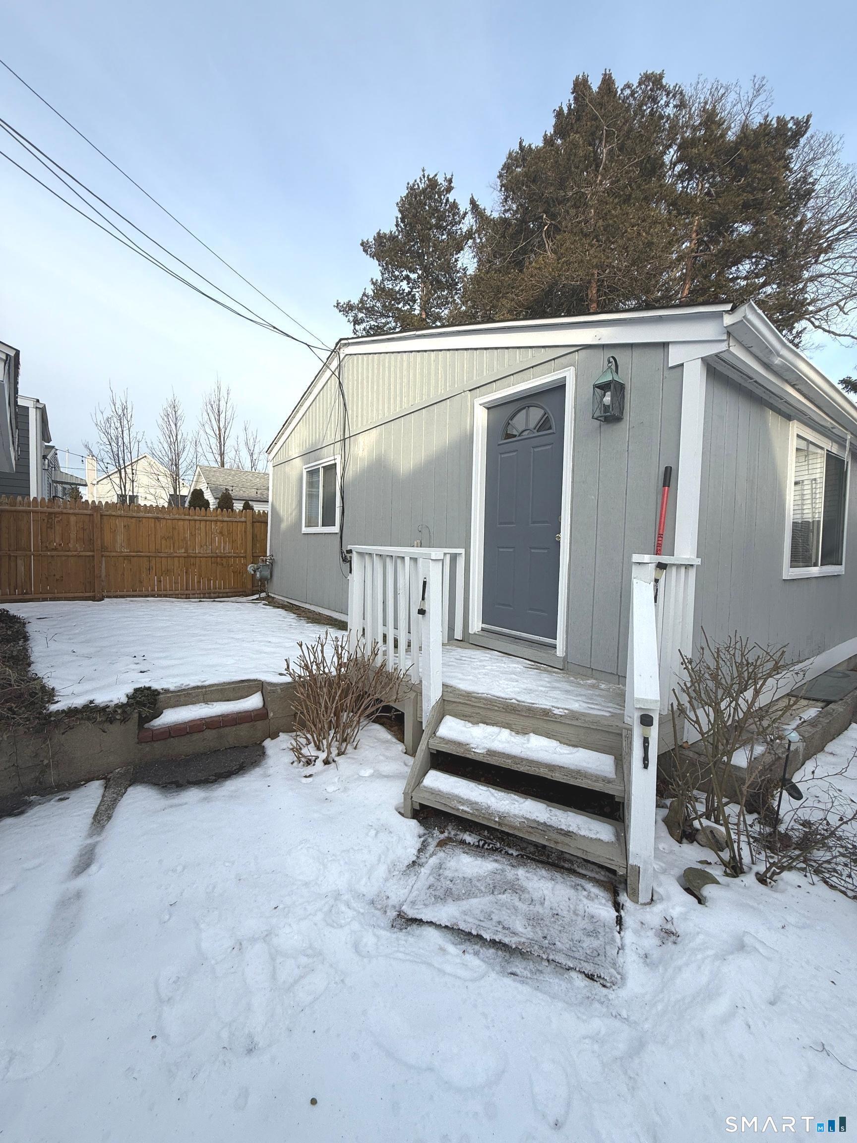 a view of a house with backyard and sitting area
