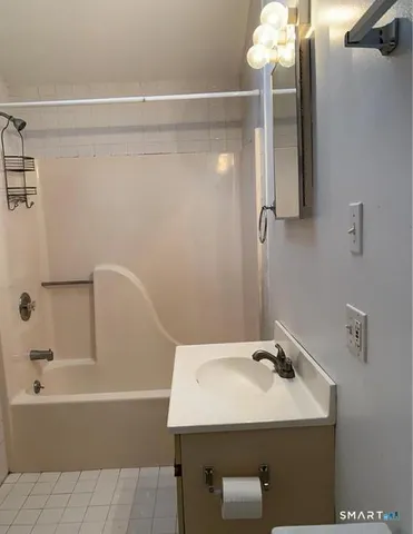 a bathroom with a sink a mirror and a bathtub