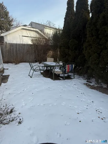 a view of backyard with barbeque grill and outdoor seating