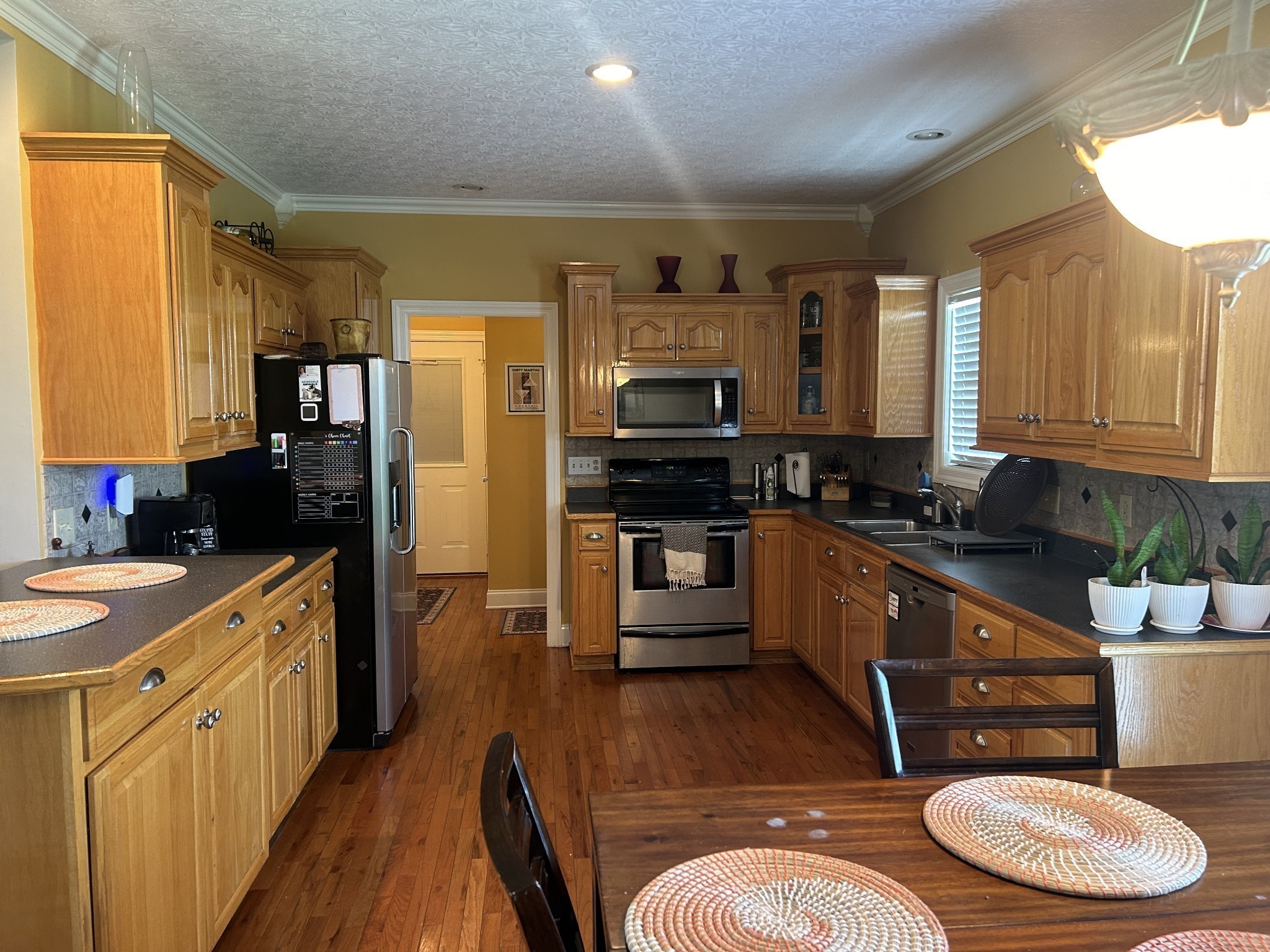 3421 George Olive Road Iron City, TN 38463 - Photo 26 of 51 a kitchen with stainless steel appliances a stove a sink dishwasher a refrigerator white cabinets and wooden floor