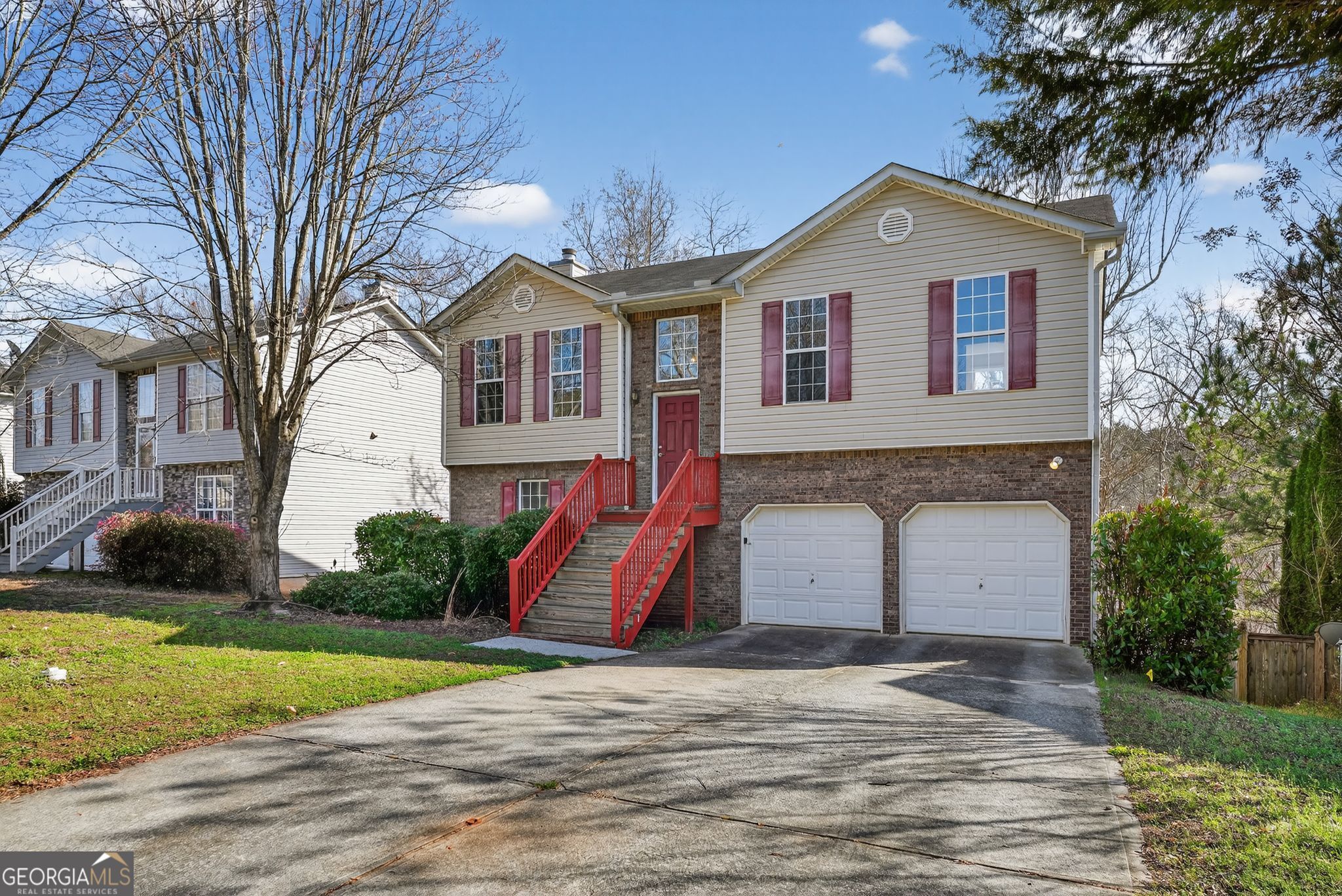 3255 River Run Trail Decatur, GA 30034 - Photo 2 of 37 a front view of a house with a yard and garage