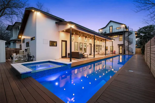 a view of a house with pool and sitting area