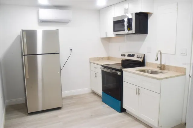 a kitchen with stainless steel appliances a refrigerator and a sink