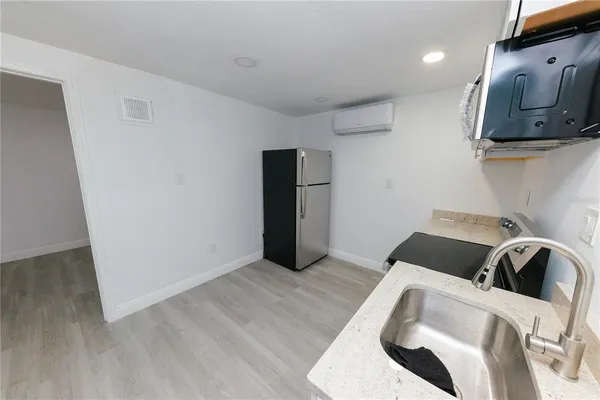 a view of a room with wooden floor