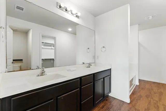 a bathroom with a sink double vanity and a mirror
