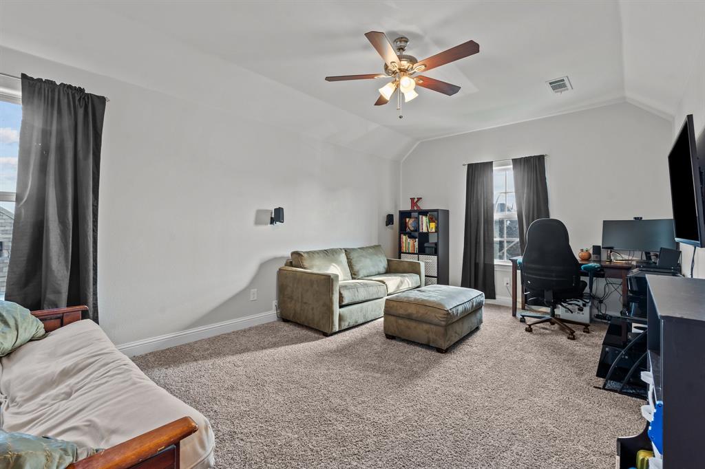 220 Flower Ridge Drive Fort Worth, TX 76108 - Photo 23 of 34 a living room with furniture a flat screen tv and a window