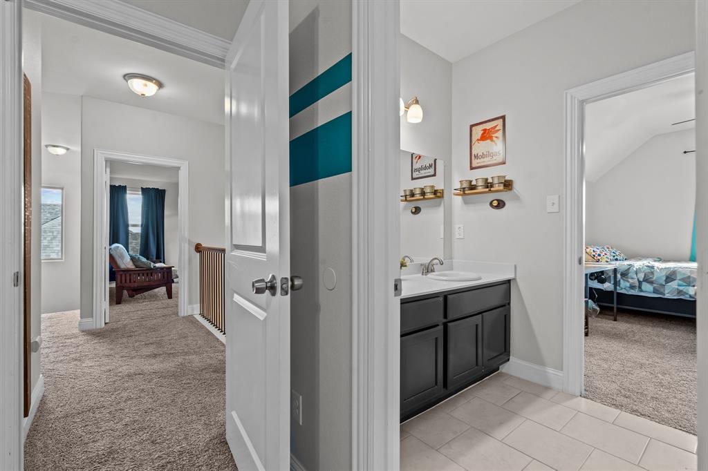 220 Flower Ridge Drive Fort Worth, TX 76108 - Photo 26 of 34 a bathroom with a sink and mirror