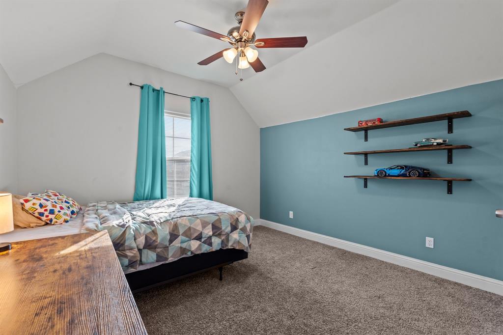 220 Flower Ridge Drive Fort Worth, TX 76108 - Photo 28 of 34 a bedroom with a bed and a chandelier fan