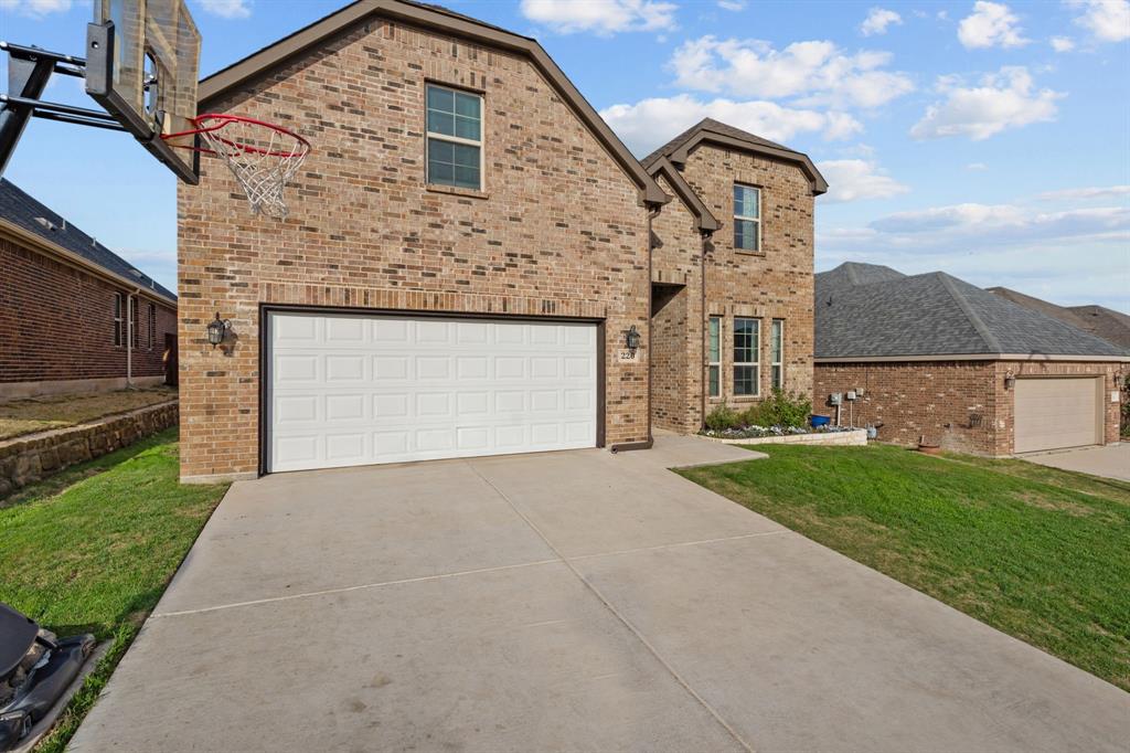 220 Flower Ridge Drive Fort Worth, TX 76108 - Photo 4 of 34 a front view of a house with a yard and garage