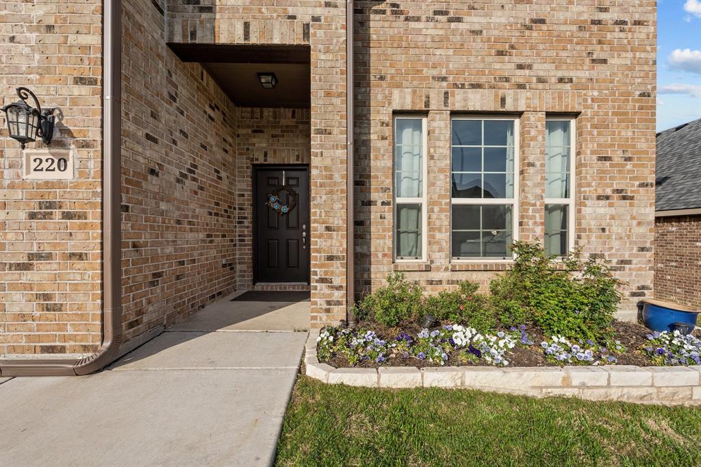 220 Flower Ridge Drive Fort Worth, TX 76108 - Photo 5 of 34 a front view of a house with a garden