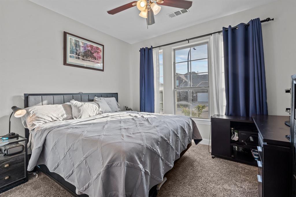 220 Flower Ridge Drive Fort Worth, TX 76108 - Photo 8 of 34 a bedroom with a bed and a chandelier