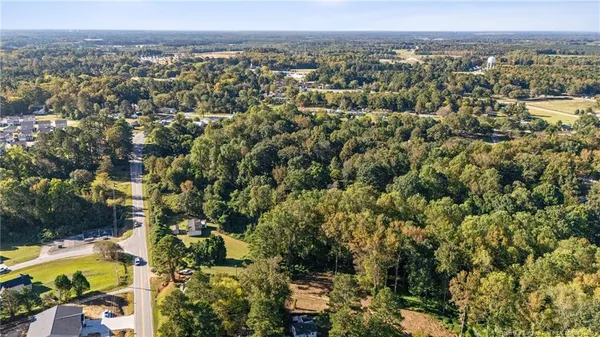 an aerial view of a residential houses with city view