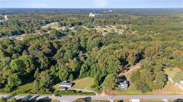 an aerial view of a houses with a yard