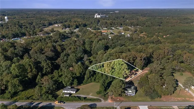 an aerial view of a house with a mountain