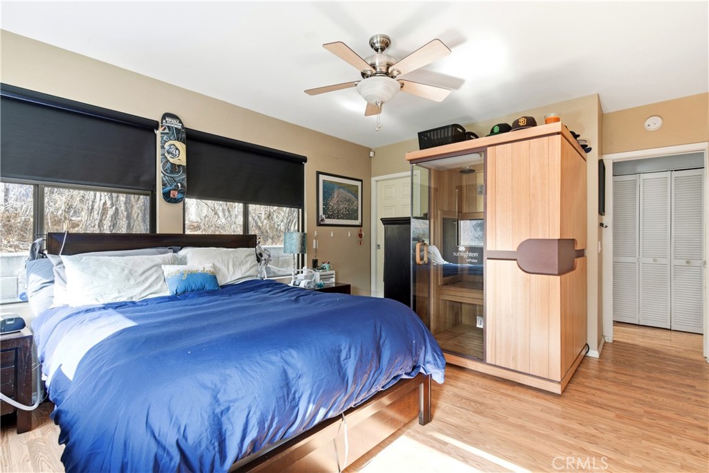 5652 Sycamore Street Wrightwood, CA 92397 - Photo 15 of 50 a spacious bedroom with a bed and a large mirror
