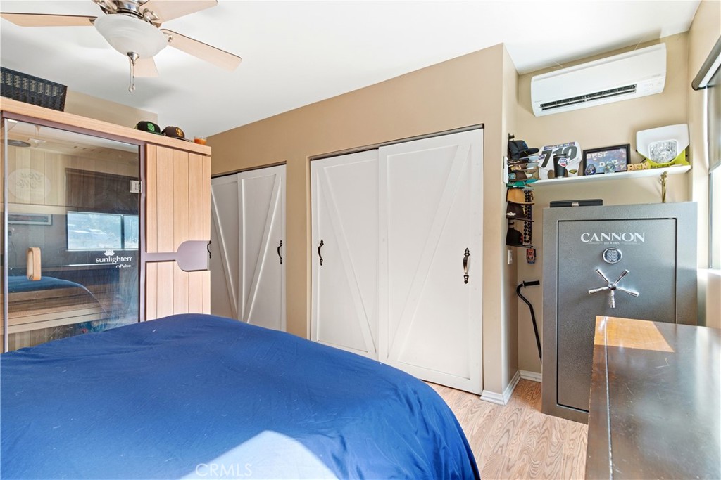 5652 Sycamore Street Wrightwood, CA 92397 - Photo 16 of 50 a bedroom with a bed and a walk in closet