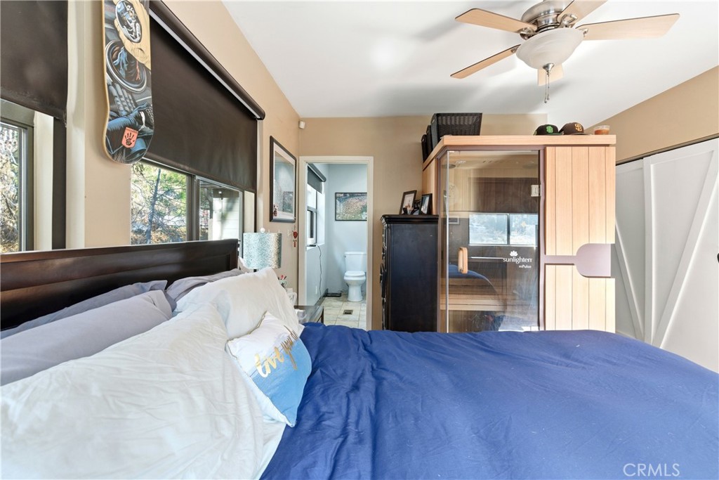 5652 Sycamore Street Wrightwood, CA 92397 - Photo 17 of 50 a bedroom with a bed and wooden floor