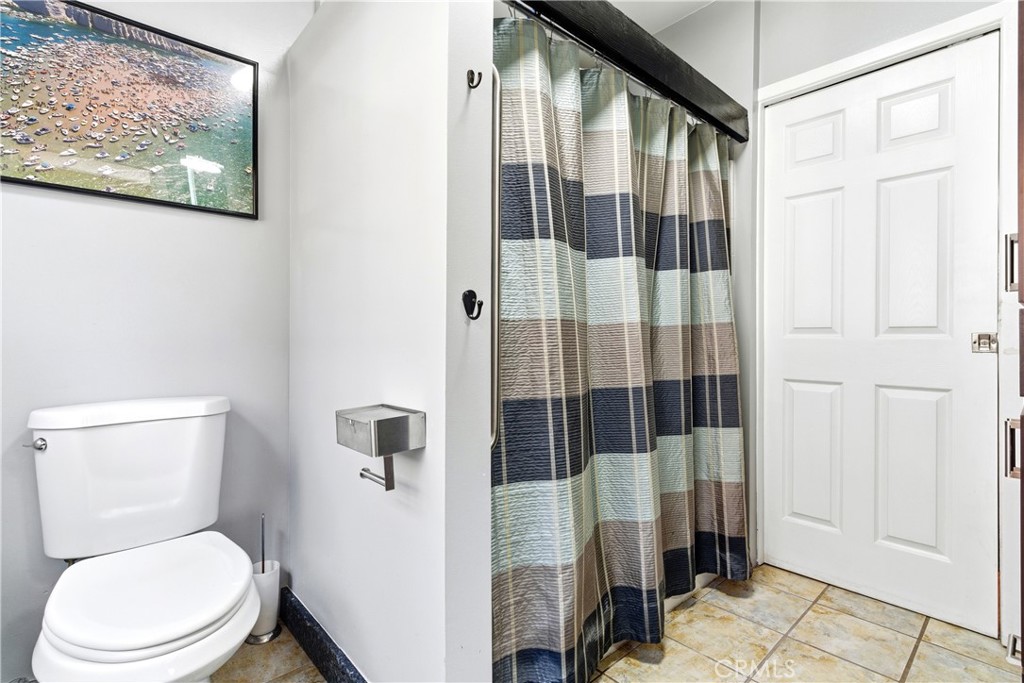 5652 Sycamore Street Wrightwood, CA 92397 - Photo 19 of 50 a white toilet sitting next to a bathroom next to a shower