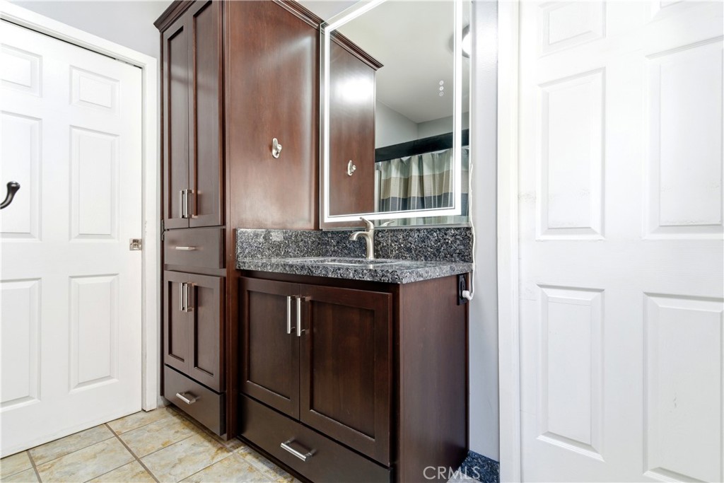 5652 Sycamore Street Wrightwood, CA 92397 - Photo 20 of 50 a bathroom with a granite countertop sink and a mirror