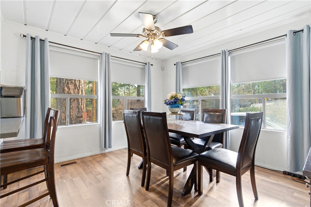 5652 Sycamore Street Wrightwood, CA 92397 - Photo 29 of 50 a view of a dining room with furniture a chandelier and wooden floor