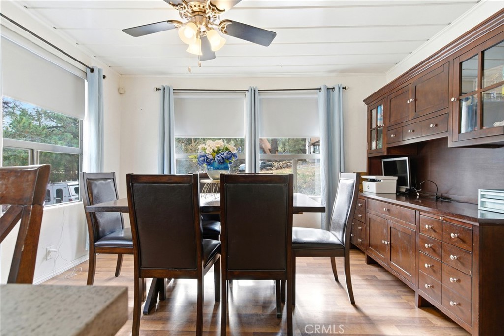 5652 Sycamore Street Wrightwood, CA 92397 - Photo 30 of 50 a dining room with furniture a chandelier and wooden floor