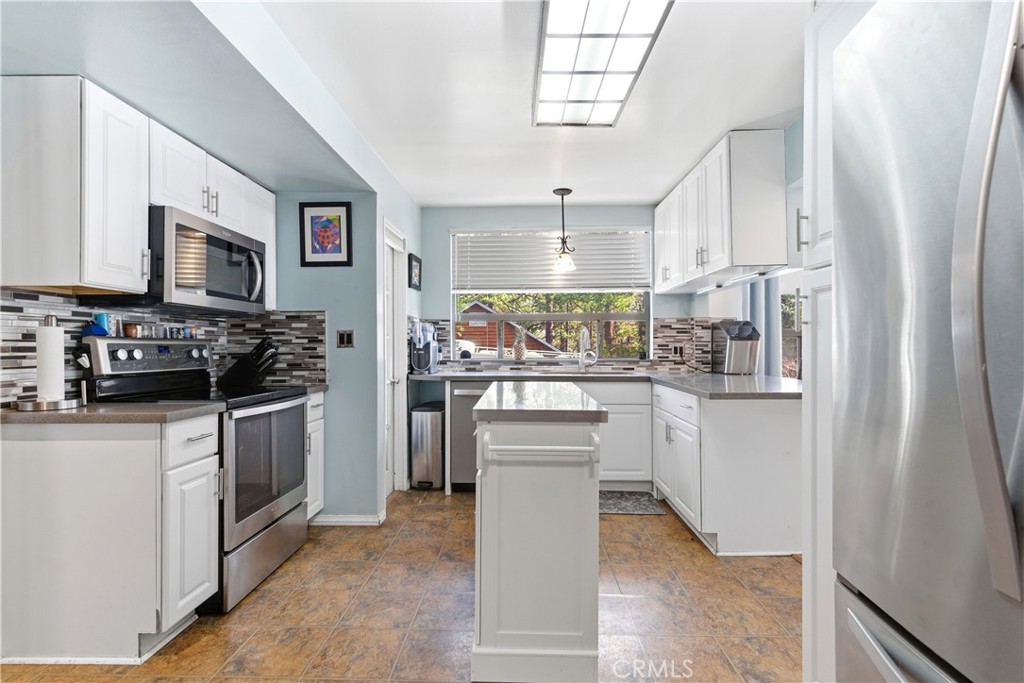5652 Sycamore Street Wrightwood, CA 92397 - Photo 33 of 50 a kitchen with white cabinets and appliances