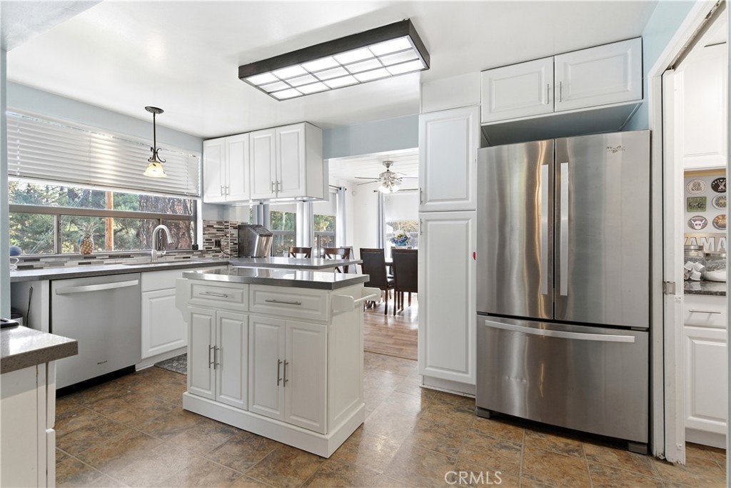 5652 Sycamore Street Wrightwood, CA 92397 - Photo 34 of 50 a kitchen with white cabinets and stainless steel appliances
