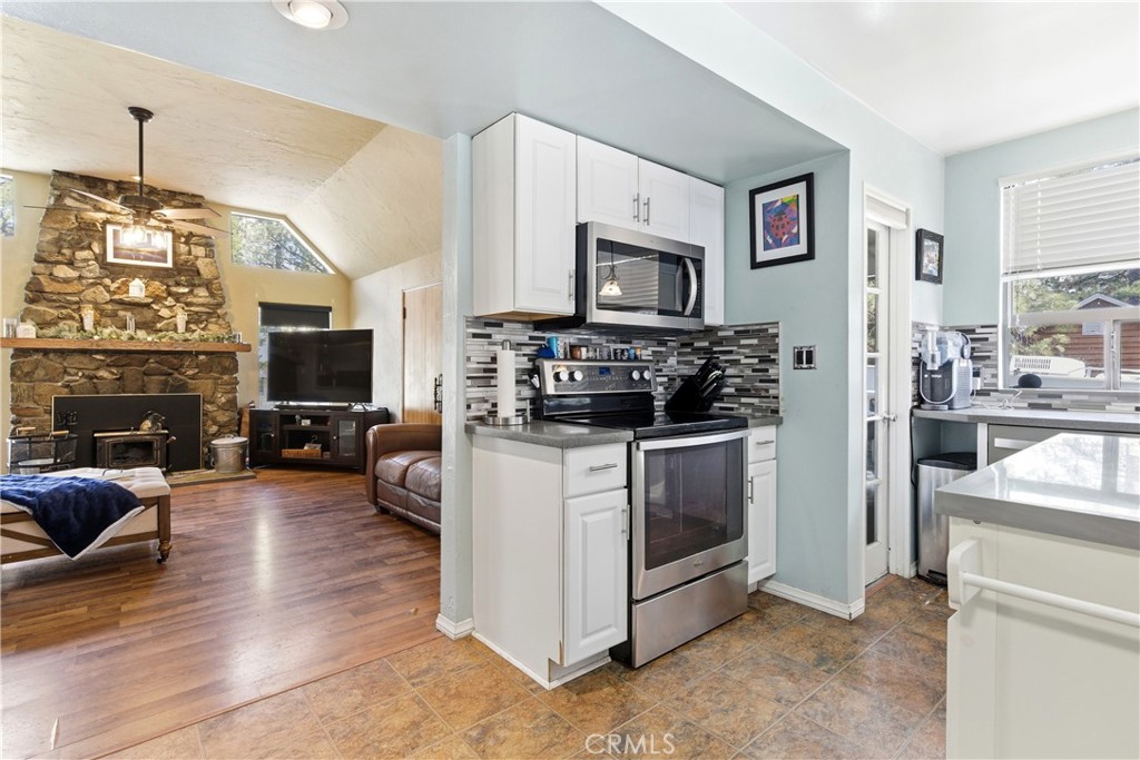 5652 Sycamore Street Wrightwood, CA 92397 - Photo 36 of 50 a kitchen with stainless steel appliances a stove a sink and a refrigerator