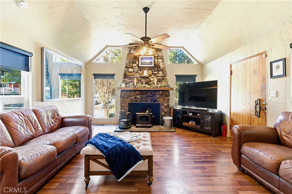 5652 Sycamore Street Wrightwood, CA 92397 - Photo 37 of 50 a living room with furniture a flat screen tv and a fireplace
