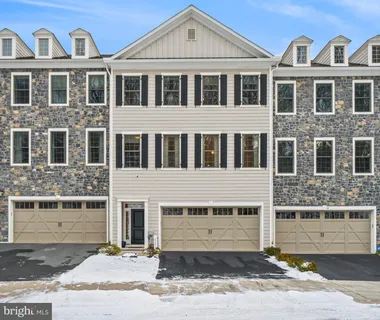 a kitchen with a refrigerator a white stove a dining table and chairs