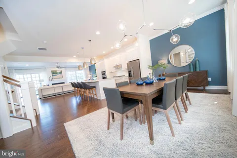 a kitchen with a table and a chandelier