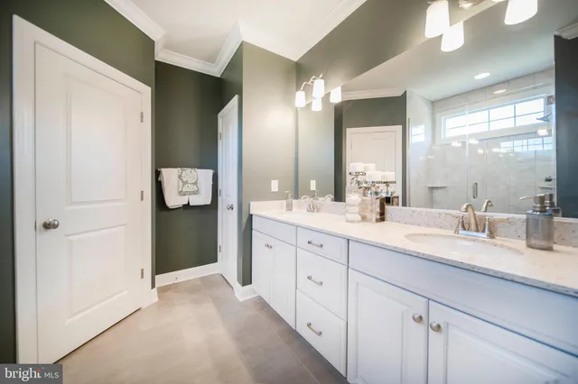 a bathroom with a sink vanity and mirror