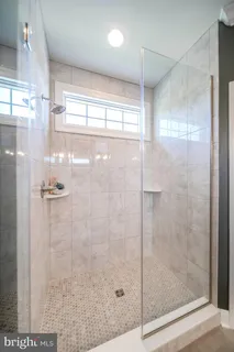 a spacious bathroom with a double vanity sink and mirror