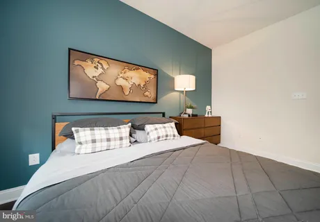 a bedroom with a bed and a chandelier