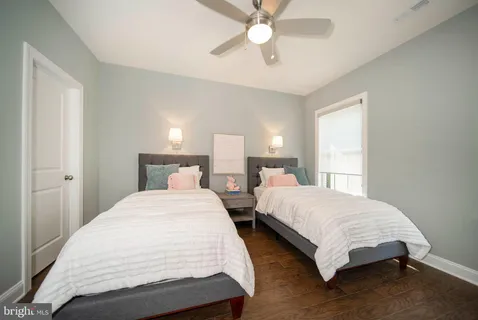 a spacious bedroom with two large bed and a large window