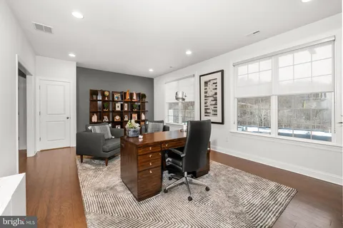 a living room with furniture a rug and a table