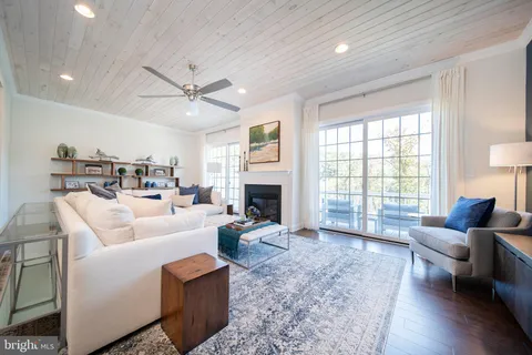 a bathroom with a toilet a sink a glass door a shower and a mirror