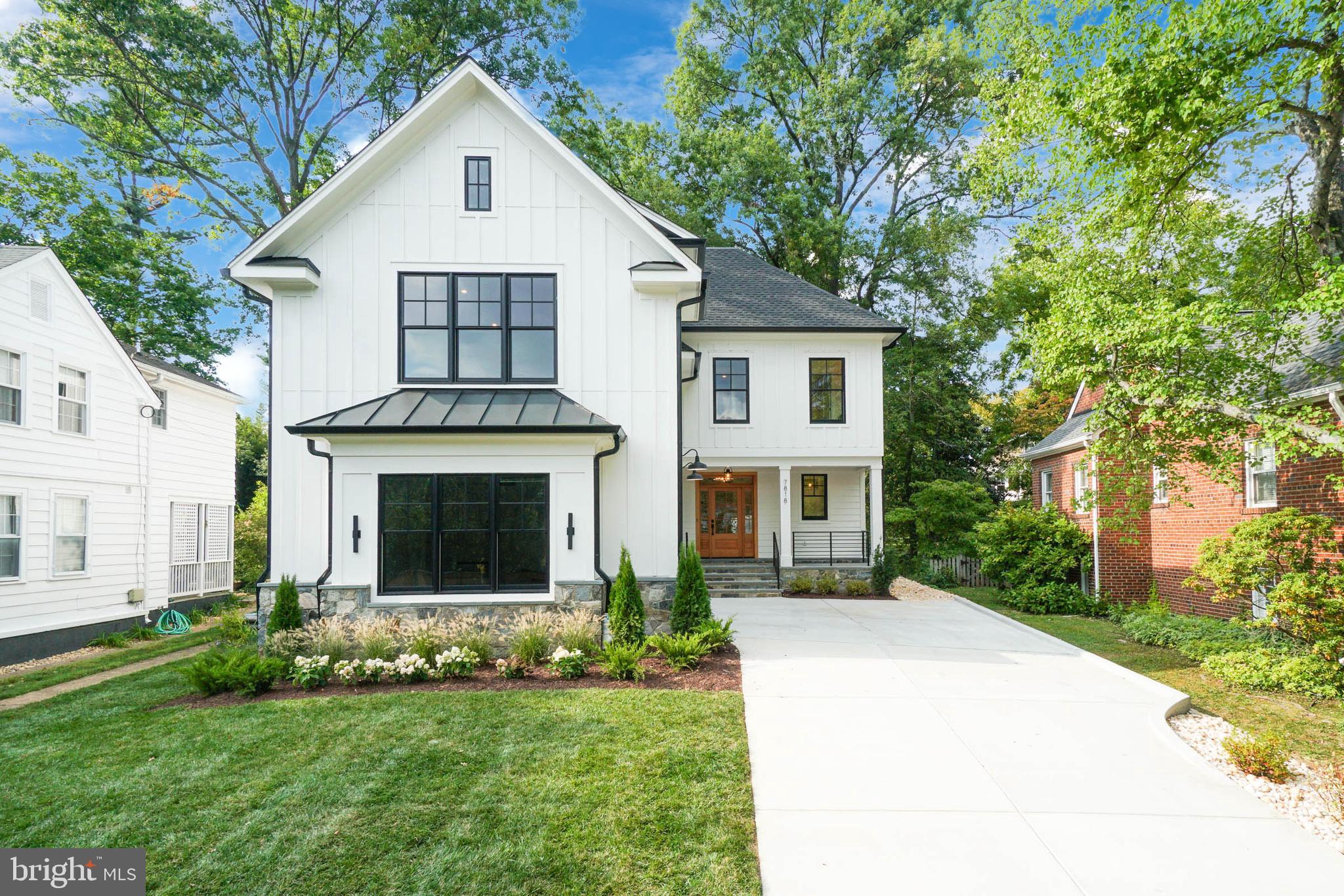 7818 Glenbrook Road Bethesda, MD 20814 - Photo 1 of 95 a front view of a house with a yard and garage